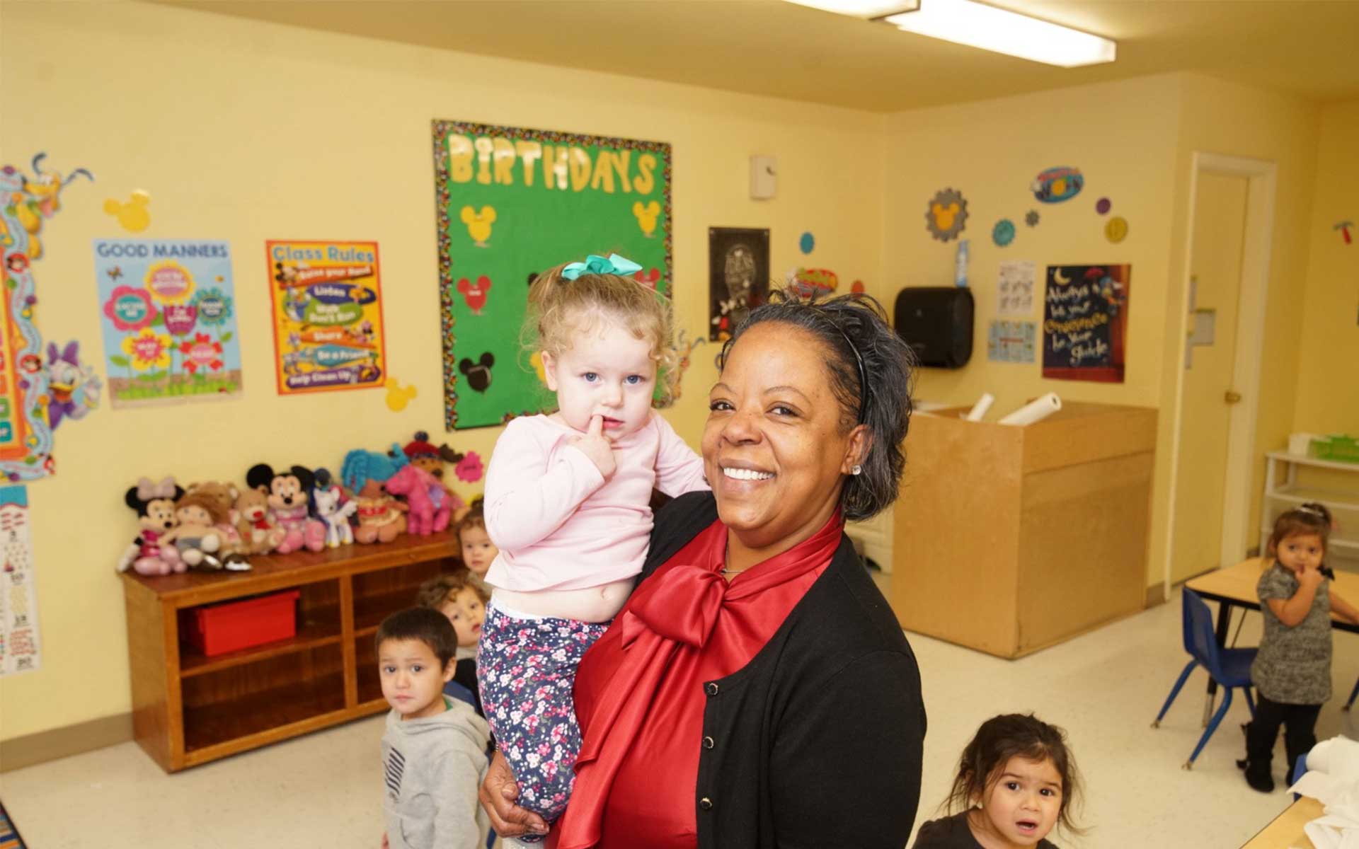 image of daycare teacher with student at luv n care